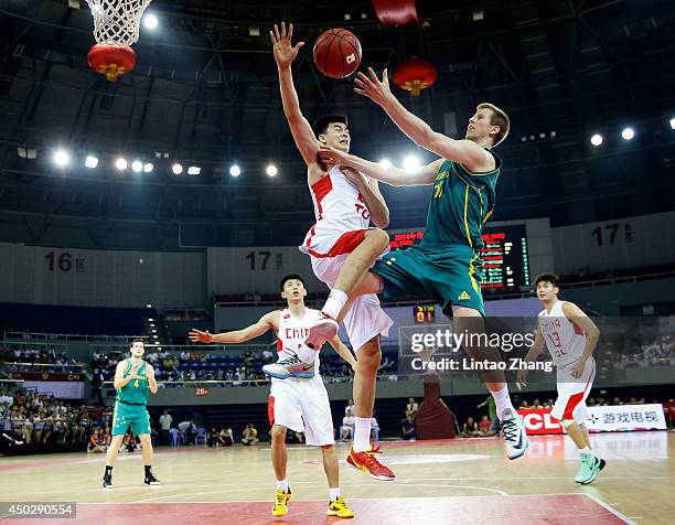 Brock Motum of Australia drives to the basket against Li Muhao of china during the 2014 Sino-Australia Men's International Basketball Challenge match...