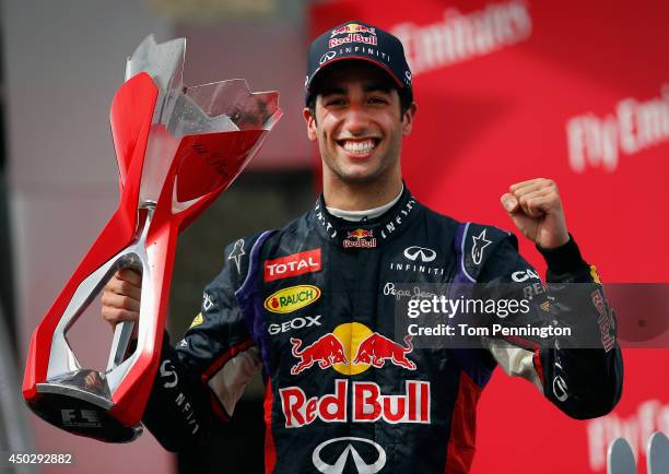 Racewinner Daniel Ricciardo of Australia and Infiniti Red Bull Racing lifts the trophy following his victory during the Canadian Formula One Grand...