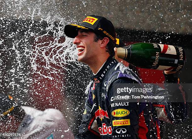 Racewinner Daniel Ricciardo of Australia and Infiniti Red Bull Racing is sprayed with champagne by teammate Sebastian Vettel of Germany and Infiniti...