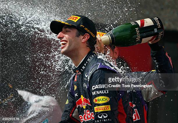 Racewinner Daniel Ricciardo of Australia and Infiniti Red Bull Racing is sprayed with champagne by teammate Sebastian Vettel of Germany and Infiniti...