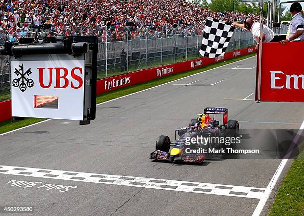 Daniel Ricciardo of Australia and Infiniti Red Bull Racing crosses the finish line to take his first Grand Prix victory during the Canadian Formula...