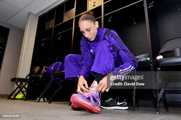 Diana Taurasi of the Phoenix Mercury ties her shoes in the locker room before a game against the San Antonio Stars at AT&T Center on June 7, 2014 in...