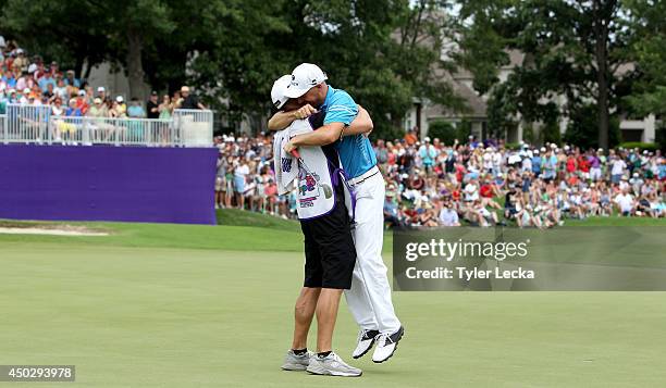 Ben Crane celebrates with caddie Joel Stock during the final round of the FedEx St. Jude Classic at the TPC Southwind on June 8, 2014 in Memphis,...