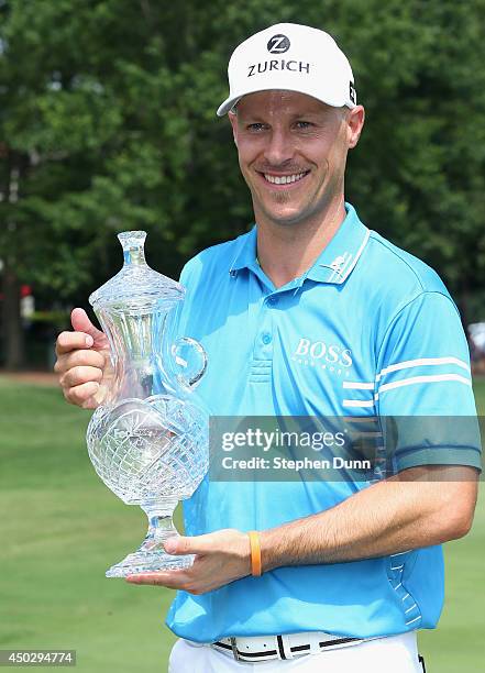 Ben Crane poses with the trophy after finishing as champion after the final round of the FedEx St. Jude Classic at the TPC Southwind on June 8, 2014...