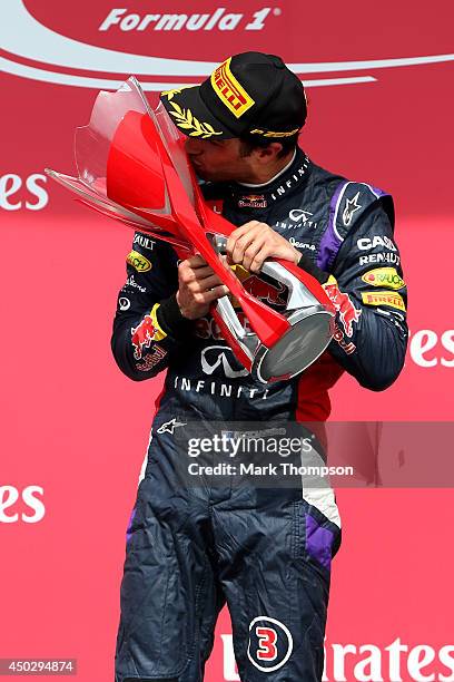 Racewinner Daniel Ricciardo of Australia and Infiniti Red Bull Racing kisses the trophy following his first Grand Prix victory during the Canadian...