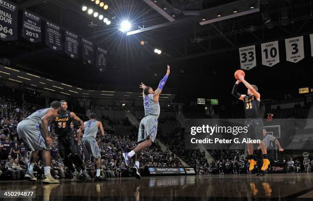 Guard McKay LaSalle of the Long Beach State 49ers puts up a shot against guard Marcus Foster of the Kansas State Wildcats during the first half on...