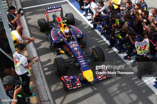 Racewinner Daniel Ricciardo of Australia and Infiniti Red Bull Racing is congratulated by his pit crew following his first Grand Prix victory during...