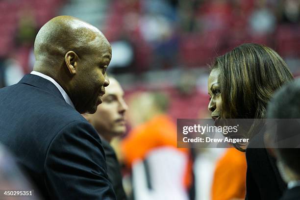 First lady Michelle Obama talks to brother and head coach of Oregon State Craig Robinson during a men's NCCA basketball game between University of...