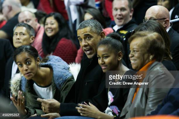 Malia Obama, U. S. President Barack Obama, Sasha Obama and Marian Robinson attend a men's NCCA basketball game between University of Maryland and...
