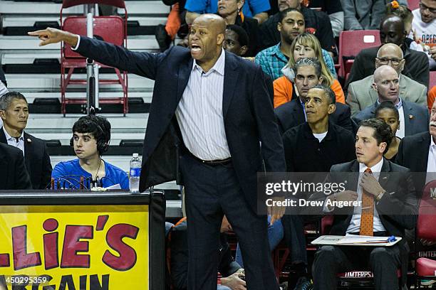 Oregon State Coach Craig Robinson coaches his team as U.S. President Barack Obama looks on during a men's NCCA basketball game between University of...