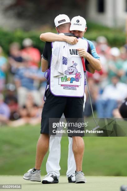 Ben Crane celebrates with his caddie Joel Stock after winning the FedEx St. Jude Classic in the final round at the TPC Southwind on June 8, 2014 in...