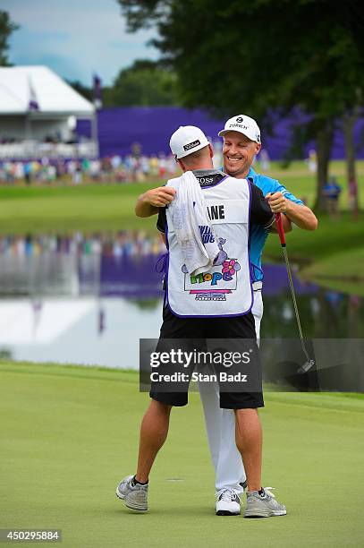 Ben Crane celebrates with caddie Joel Stock during the final round of the FedEx St. Jude Classic at TPC Southwind on June 8, 2014 in Memphis,...