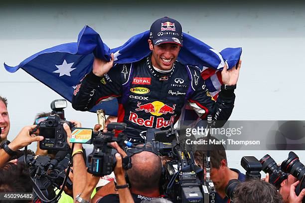 Racewinner Daniel Ricciardo of Australia and Infiniti Red Bull Racing is carried aloft by his pit crew following his frst grand prix victory during...