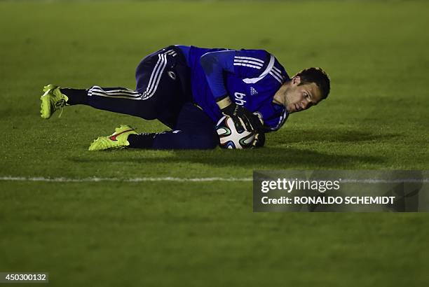 Bosnia-Herzegovina's goalkeeper Asmir Avdukic stop a ball during a training session at the Antonio Fernandez Stadium in Guaruja on June 8 prior to...