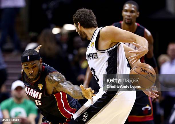 LeBron James of the Miami Heat defends against Marco Belinelli of the San Antonio Spurs during Game Two of the 2014 NBA Finals at the AT&T Center on...