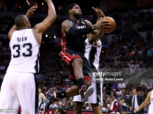 LeBron James of the Miami Heat drives to the basket against Boris Diaw of the San Antonio Spurs during Game Two of the 2014 NBA Finals at the AT&T...