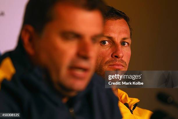 Socceroos captain Lucas Neill watches on as manager Ange Postecoglou speaks to the media at an Australian Socceroos press conference at the...