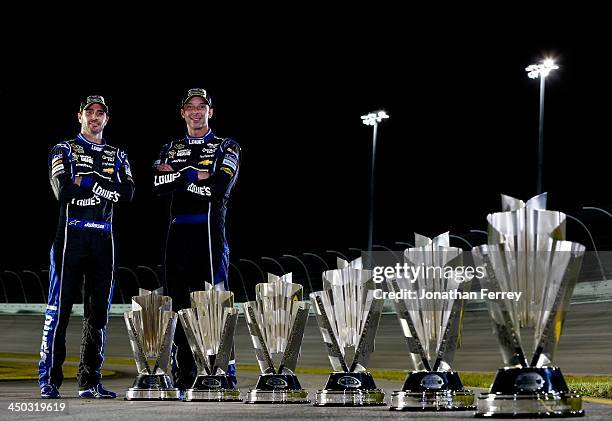 Jimmie Johnson, driver of the Lowe's/Kobalt Tools Chevrolet, and crew chief Chad Knaus pose with series championship trophies after the NASCAR Sprint...