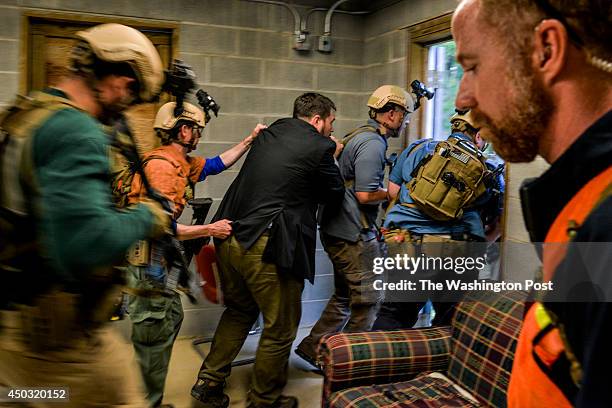 During a training exercise, special agents escort a make-believe consular general from a building under attack in the make-believe town of Erehwon,...