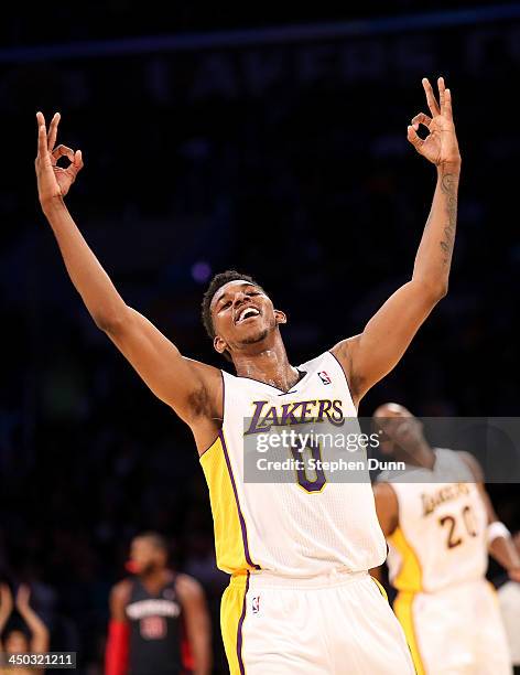 Nick Young of the Los Angeles Lakers celebrates after a three point basket by Jodie Meeks in the fourth quarter against the Detroit Pistons at...