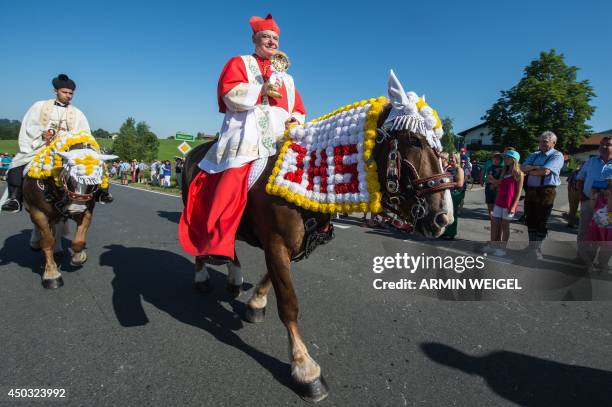 Cardinal Gerhard Ludwig Mueller participates in the Pentecostal horse ride parade on June 9, 2014 near Bad Koetzting, Germany. The procession with...