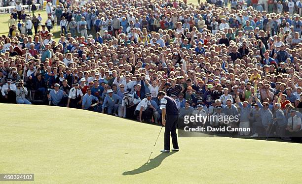 Nick Faldo of England hits his final putt on the 18th green on the way to his win in the 119th Open Championship played on the Old Course at St...