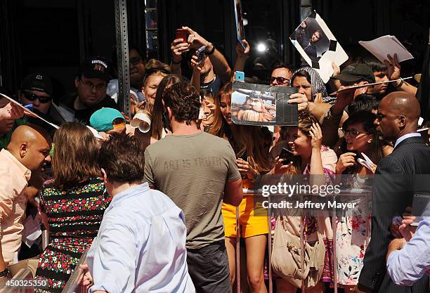 Actor Gerard Butler signs for fans at the Los Angeles premiere of 'How To Train Your Dragon 2' at the Regency Village Theatre on June 8, 2014 in...