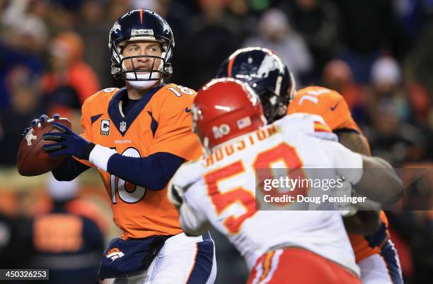 Quarterback Peyton Manning of the Denver Broncos drops back to pass as tackle Orlando Franklin of the Denver Broncos blocks outside linebacker Justin...