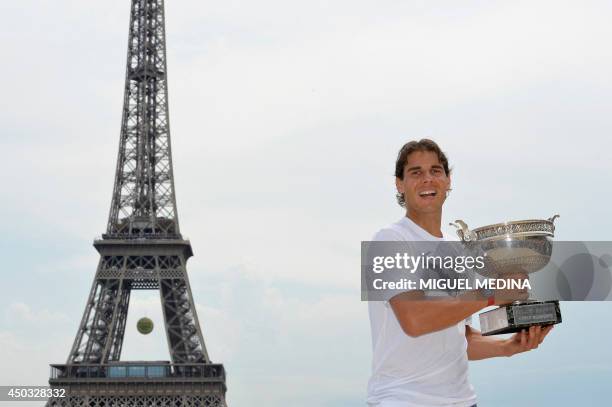 Spain's Rafael Nadal poses with the Musketeers trophy on June 9, 2014 in Paris, a day after winning the French tennis Open men's final match at the...