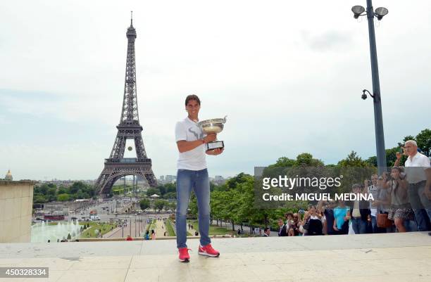 Spain's Rafael Nadal poses with the Musketeers trophy on June 9, 2014 in Paris, a day after winning the French tennis Open men's final match at the...