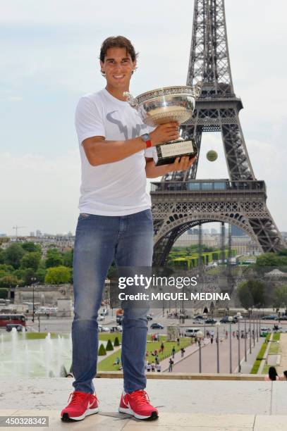 Spain's Rafael Nadal poses with the Musketeers trophy on June 9, 2014 in Paris, a day after winning the French tennis Open men's final match at the...