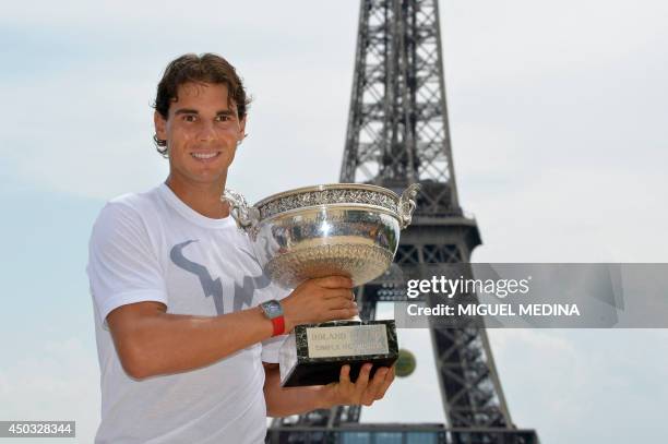 Spain's Rafael Nadal poses with the Musketeers trophy on June 9, 2014 in Paris, a day after winning the French tennis Open men's final match at the...