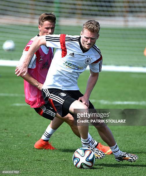 Germany's forward Andre Schuerrle and Germany's defender Erik Durm vie for the ball during a training session of Germany's national football team in...