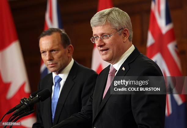 Canadian Prime Minister Stephen Harper addresses the media alongside Australian Prime Minister Tony Abbott during a joint press conference in...