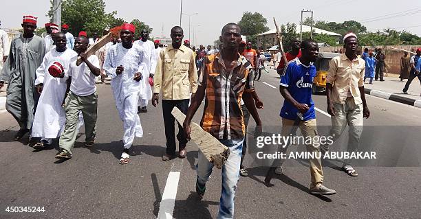 Supporters of the newly appointed emir of Kano hold a demonstration march in his support in the ancient northern Nigerian city of Kano, on June 9,...