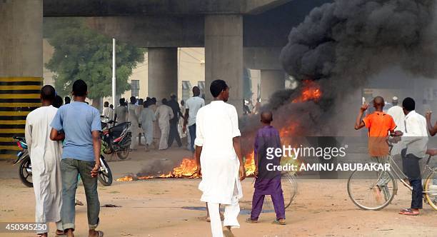 Rioters light fires on the streets of northern Nigeria's ancient city of Kano in protest over the appointment of Nigeria's former Governor of the...