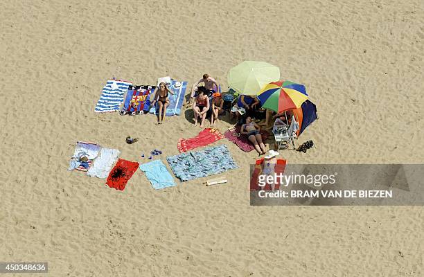 An aerial view of sunbathers on the beach in Noordwijk, the Netherlands, on June 9, 2014. AFP PHOTO / ANP / BRAM VAN DE BIEZEN
