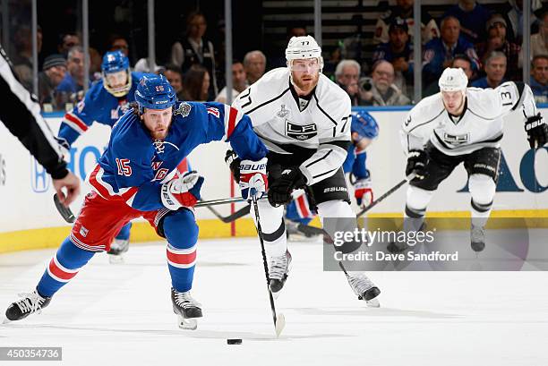 Derek Dorsett of the New York Rangers is chased by Jeff Carter of the Los Angeles Kings during the first period of Game Three of the 2014 Stanley Cup...