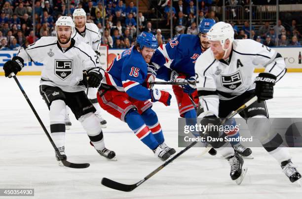 Derek Dorsett of the New York Rangers gets tangled with teammate Brian Boyle while chasing Matt Greene of the Los Angeles Kings in the first period...