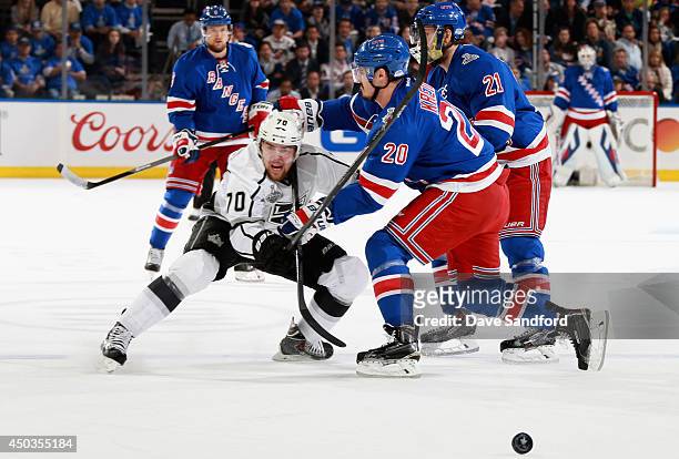 Tanner Pearson of the Los Angeles Kings is defended by Chris Kreider and Derek Stepan of the New York Rangers in the first period of Game Three of...