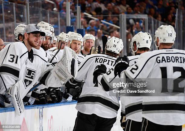 Anze Kopitar, Jake Muzzin and Marian Gaborik of the Los Angeles Kings celebrate with teammates after Muzzin scored against the New York Rangers in...