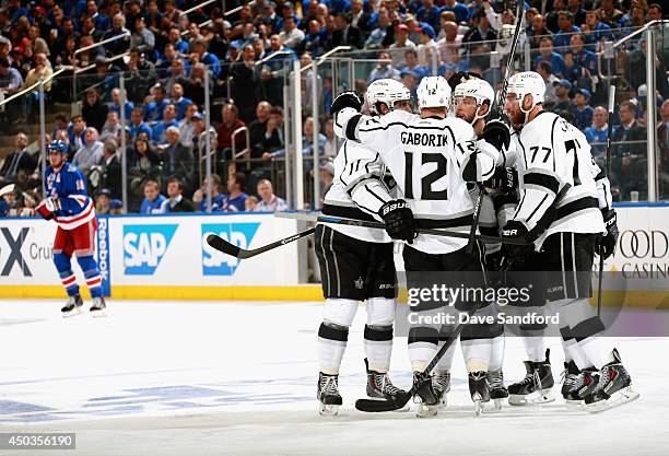 Jake Muzzin of the Los Angeles Kings celebrates with his linemates Marian Gaborik and Jeff Carter after scoring against the New York Rangers during...