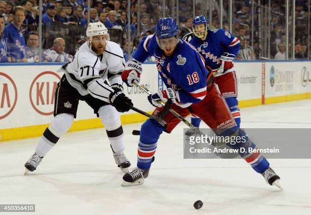Jeff Carter of the Los Angeles Kings tries to stop Marc Staal of the New York Rangers in the first period of Game Three of the 2014 Stanley Cup Final...