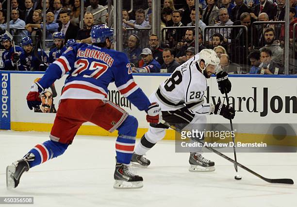 Jarret Stoll of the Los Angeles Kings is challenged by Ryan McDonagh of the New York Rangers in Game Three of the 2014 Stanley Cup Final at Madison...