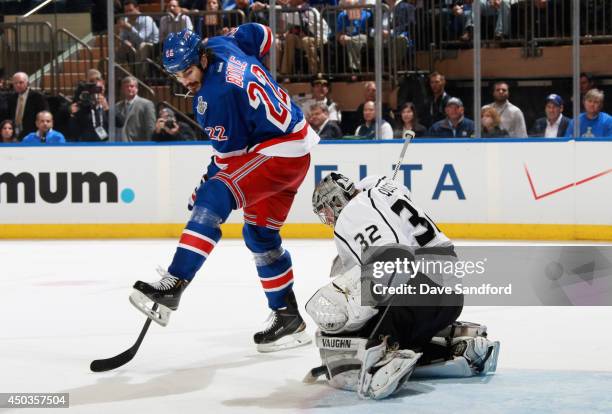 Goaltender Jonathan Quick of the Los Angeles Kings makes a pad save behind Brian Boyle of the New York Rangers during the third period of Game Three...