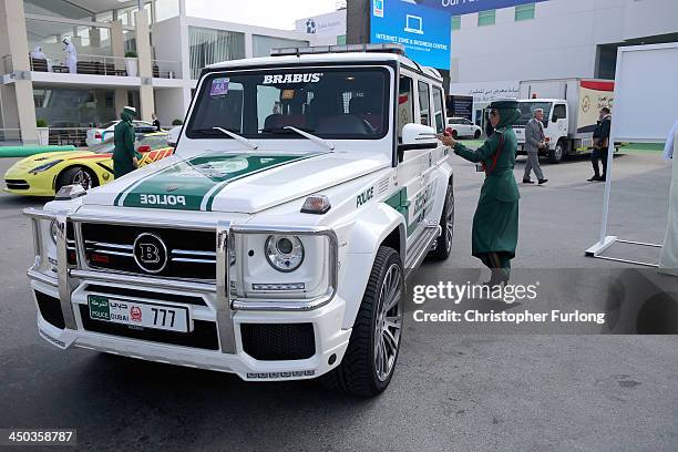 Female Emerati police officer locks her Mercedes Benz Brabus 4x4 supercar during the Dubai Airshow on November 18, 2013 in Dubai, United Arab...