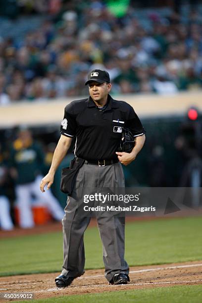 Umpire Angel Campos stands on the field during the gam between the Detroit Tigers and the Oakland Athletics at O.co Coliseum on May 27, 2014 in...