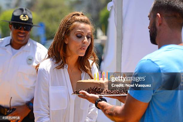 Maria Menounos blows out the candle on her birthday cake at "Extra" at Universal Studios Hollywood on June 9, 2014 in Universal City, California.