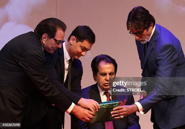 Indian Bollywood personalities Dharmendra , Aamir Khan and Amitabh Bachchan participate in the launch for the autobiography of veteran Bollywood...