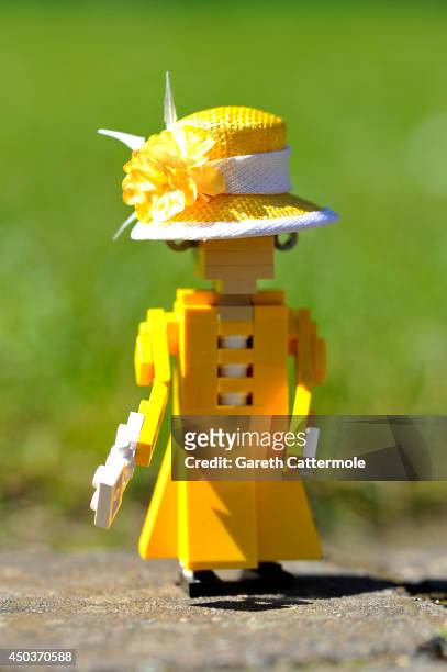 Figure of Queen Elizabeth II stands outside a LEGO Buckingham Palace wearing a designer hat by Rachel Trevor-Morgan, The Queen's milliner ahead of...